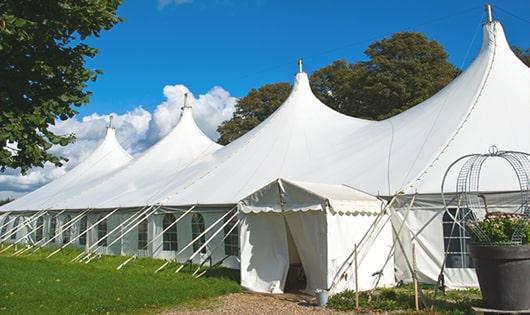 a line of portable restrooms in a shaded area, offering a comfortable experience for users in Westminster, MA